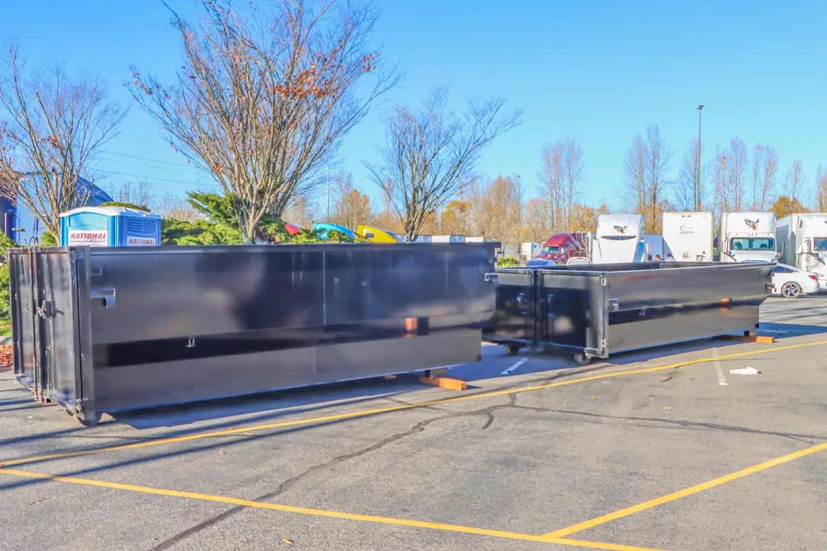 Professional dumpster rental service with roll-off container on residential driveway in Ashtabula
